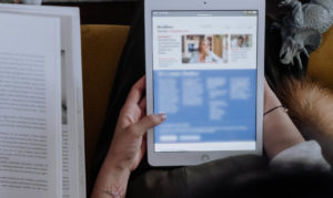 Woman reading content SEO on handheld device