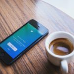 Twitter on phone and mug