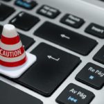 Cone saying caution on keyboard