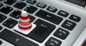 Cone saying caution on keyboard