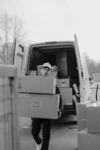 delivery man bringing parcels bought off the internet to the front door of the customer